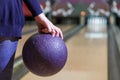 Women`s hand takes the ball for bowling close-up