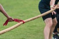 Hand Holds Bandana To Start Tug Of War Match