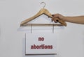 hand holds a banner with the inscription no abortions on a hanger Royalty Free Stock Photo