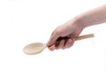 Hand holds wooden spoon on white background Royalty Free Stock Photo