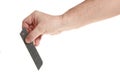 Hand holds a blade for a construction knife on a white background Royalty Free Stock Photo