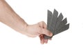 Hand holds a blade for a construction knife on a white background Royalty Free Stock Photo