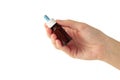 Hand holds a bottle of nasal drops isolated on white background. Space for text Royalty Free Stock Photo