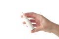 Hand holds a bottle of nasal drops isolated on white background Royalty Free Stock Photo