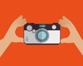 hand holds camera photo orange background design graphic