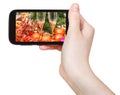 Hand holds cellphone with Xmas still life Royalty Free Stock Photo