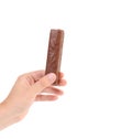 Hand holds chocolate stick. Royalty Free Stock Photo