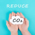 Hand holds cloud with the word CO 2, reduce carbon dioxide emission, environmental issue, air pollution