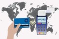 Hand holds a credit card near the payment terminal on the background of the world map. Contactless payment concept Royalty Free Stock Photo