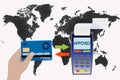 Hand holds a credit card near the payment terminal on the background of the world map. Contactless payment concept Royalty Free Stock Photo