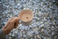 Hand holds a cup of milk with cocoa on a background of puzzle pieces