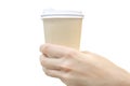 Hand holds a disposable paper cup with a hot drink, coffee, isolated on a white background Royalty Free Stock Photo