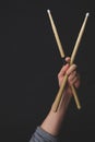 Hand holds drumsticks in the dark. copy space Royalty Free Stock Photo