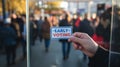 Early Voting Sign Held by Hand in Front of Blurred Crowd AI generated. Royalty Free Stock Photo