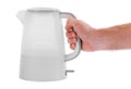 Hand holds an electric kettle plastic on a white isolated background Royalty Free Stock Photo