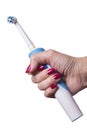 Hand holds electric toothbrush against white Royalty Free Stock Photo