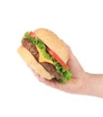 Hand holds fresh hamburger.