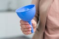 hand holds a funnel on white background