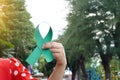 Hand holds green awareness ribbon. Royalty Free Stock Photo