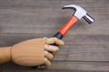 Hand holds a hammer