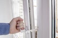 The hand holds the handle of window with restrictor Royalty Free Stock Photo