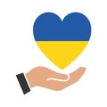 A hand holds a heart in the colors of the flag of Ukraine. The concept of peace in Ukraine. Love for country and nation. Royalty Free Stock Photo