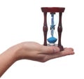 Hand holds an hourglass