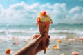 Hand holds ice cream with a sea backdrop Summer delight