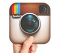 Hand holds Instagram logotype Royalty Free Stock Photo