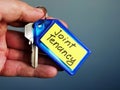 Hand holds key with Joint Tenancy inscription