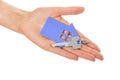 Hand holds key with a keychain the shape of house. Royalty Free Stock Photo