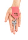 Hand holds key with a keychain the shape of house. Royalty Free Stock Photo