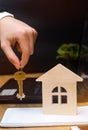 The hand holds the keys and model of the house. real estate buying an apartment