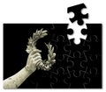 Hand holds a laurel wreath - bronze statue on black background - Success and fame concept in jigsaw puzzle shape