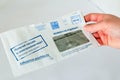 a hand holds a letter with notification of traffic violations. Text in Russian: Samara, non-refundable, I receive it in electroni