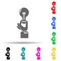 A hand holds a light bulb ideas multi color style icon. Simple glyph, flat vector of sucsess and awards icons for ui and ux, Royalty Free Stock Photo