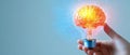 A hand holds a light bulb that transforms into a vibrant brain, symbolizing the fusion of creativity and intelligence