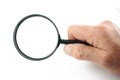 Hand holds magnifying glass  on white background Royalty Free Stock Photo