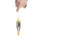 Hand holds a metal plumb line on a cord on a white background