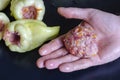 Hand holds minced meat for stuffing bell pepper