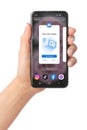 Hand holds mobile phone with Zoom Meetings app on its screen