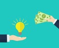 Hand holds money, hand holds light bulb. Investing in innovation, buy ideas, strategy, modern technology business