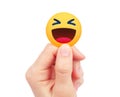 Hand holds new Facebook Haha Empathetic Emoji Reaction