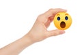 Hand holds new Facebook Wow Empathetic Emoji Reaction