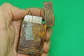 Hand holds an old brown open shabby metal lighter Royalty Free Stock Photo