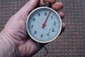 Hand holds one old round scales Royalty Free Stock Photo