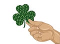 Hand holds ornate clover tree-leaf. Celebration concept Patrick