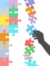 Hand holds piece to solve falling puzzle Royalty Free Stock Photo