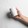 A hand holds a plain white ceramic mug against a white background Royalty Free Stock Photo