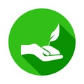 the hand holds the plant green icon in Badge style with shadow Royalty Free Stock Photo